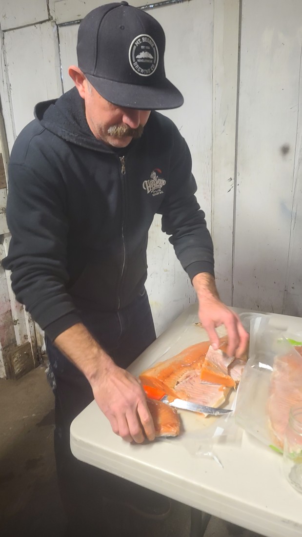 Camp cook preparing meal ingredients before a stillwater trip