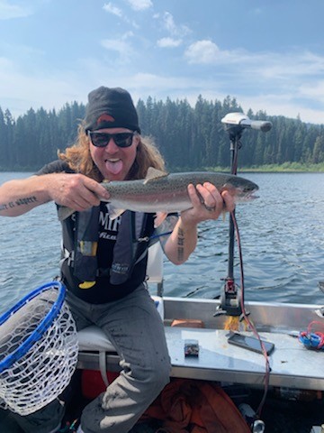 Stillwater trout landed from a compact boat setup
