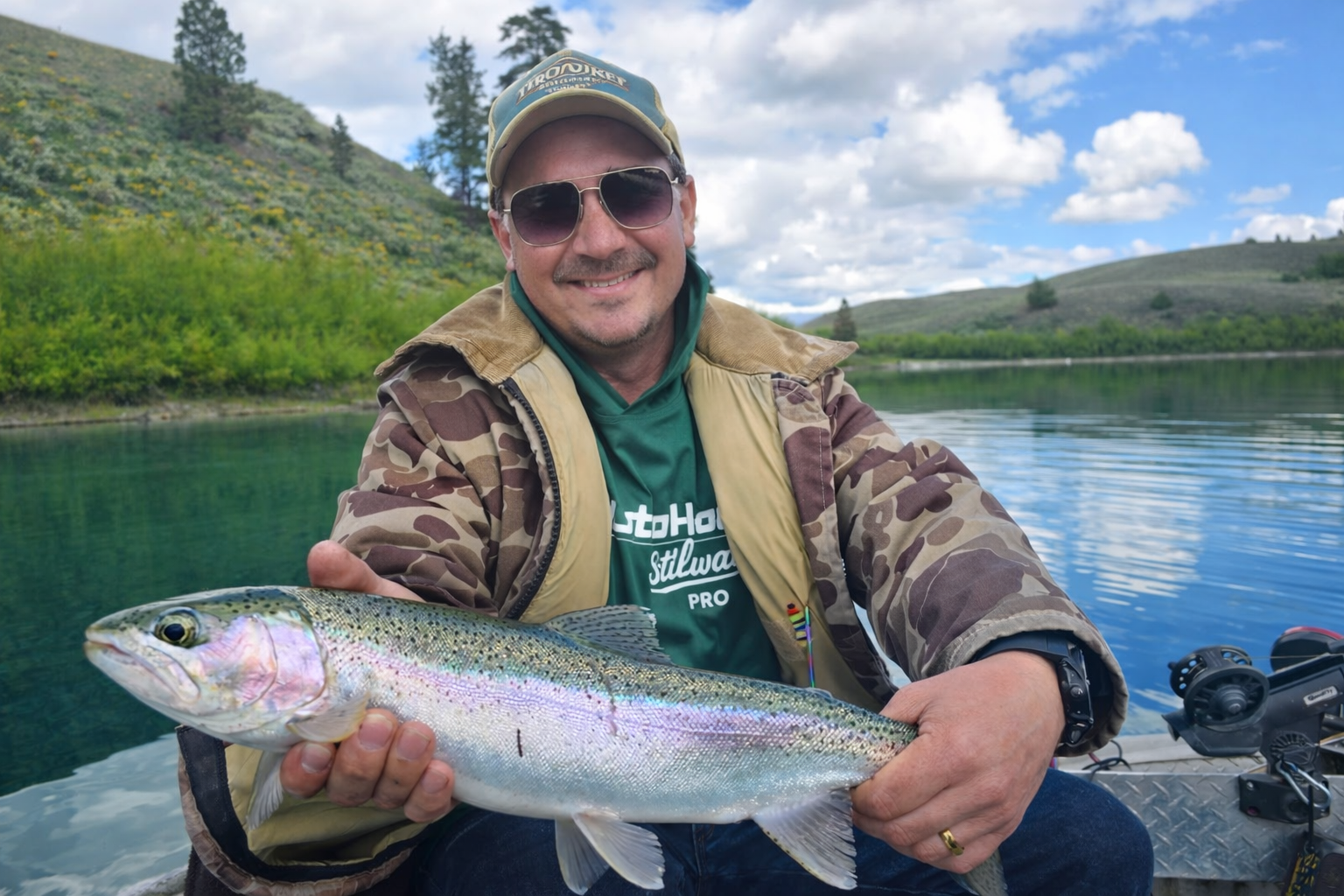 Trevor Thurston with a rainbow trout on the water